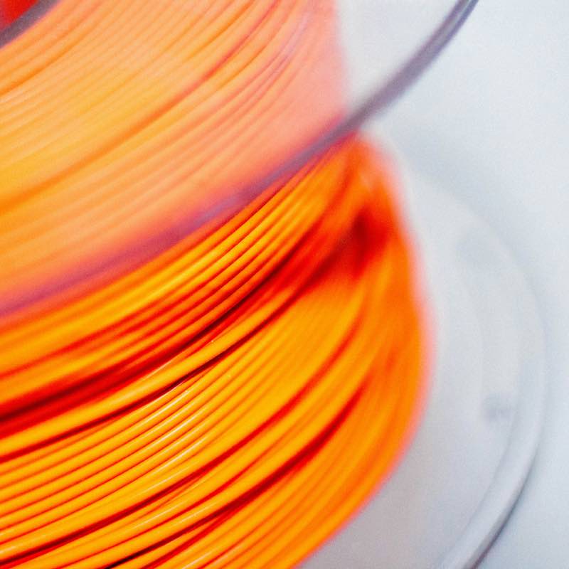Orange filament on a spool